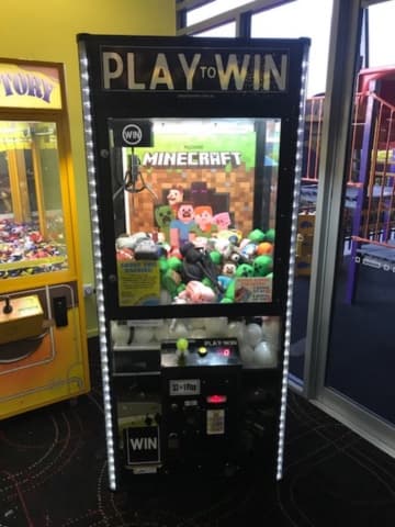 Play to Win claw machine with branded prizes